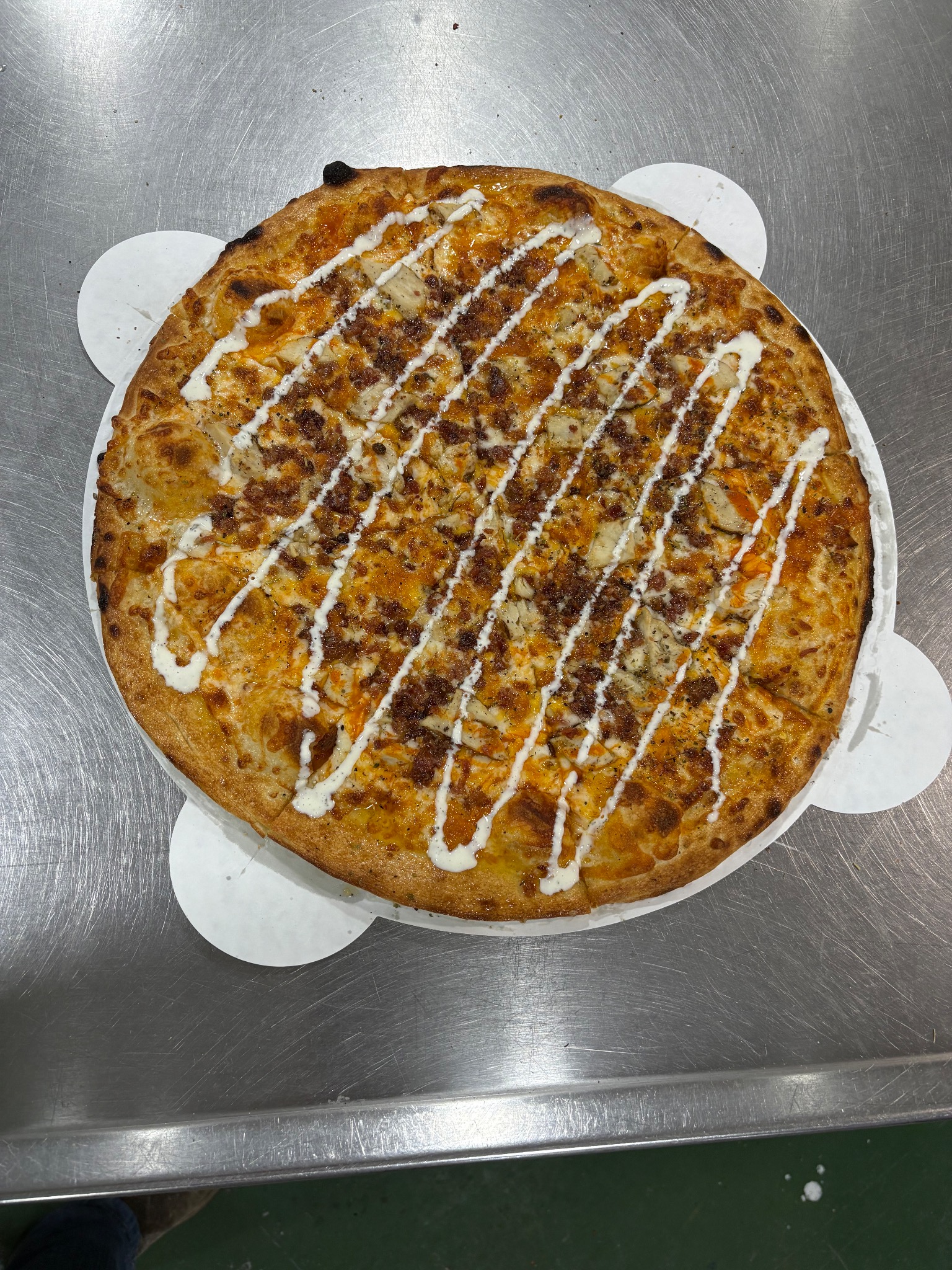 Buffalo chicken pizza with ranch drizzle